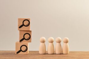 wooden-people-figures-and-magnifying-glass-icons